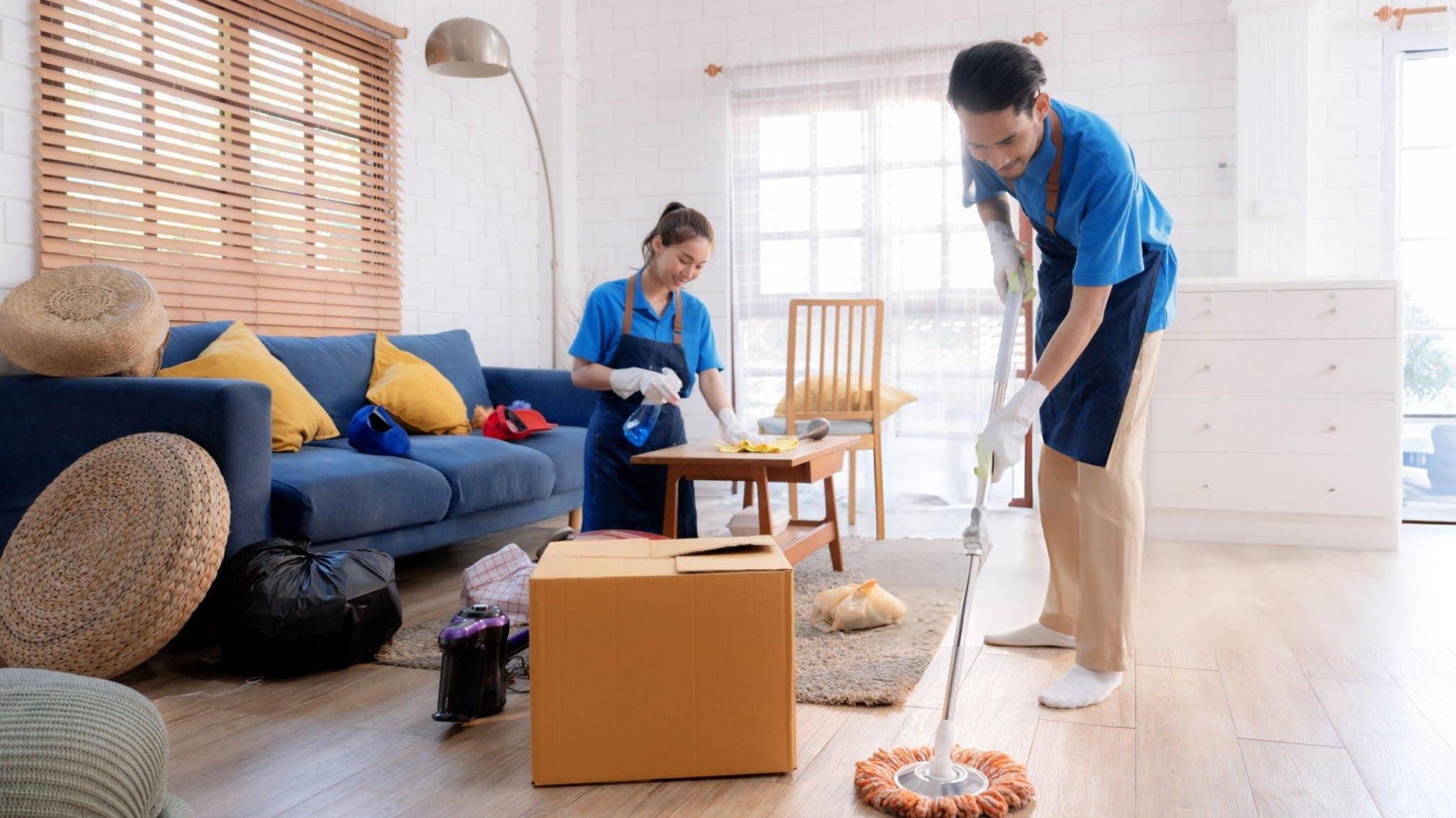 Bright, clean living room with polished floors and cleaning tools, representing a freshly deep-cleaned home.